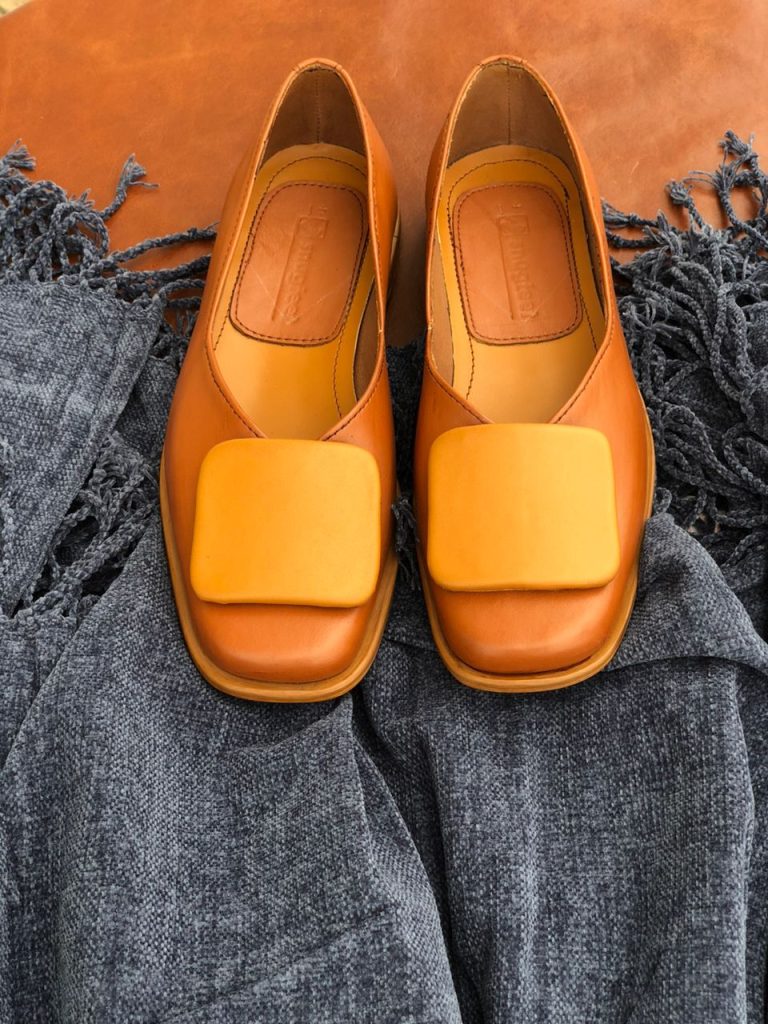 Contrasting tan flats with a square toe and square detail for a fashion-forward woman
